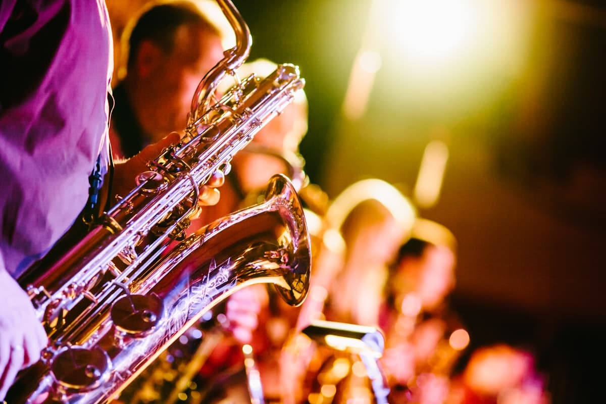 A brass section of trumpet and saxophone players performing together on stage